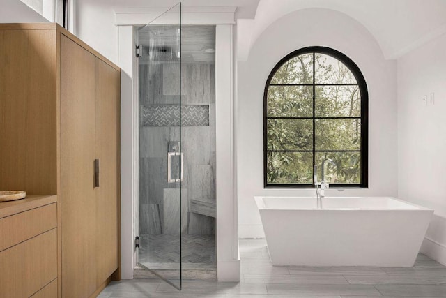 bathroom featuring a freestanding bath and a stall shower