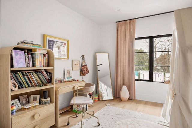 office space featuring baseboards and wood finished floors