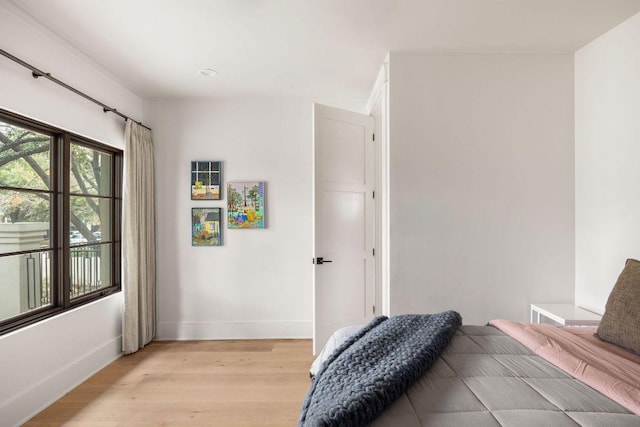 bedroom featuring light wood-type flooring and baseboards