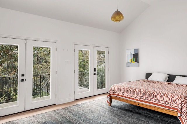 bedroom featuring access to exterior, lofted ceiling, and french doors