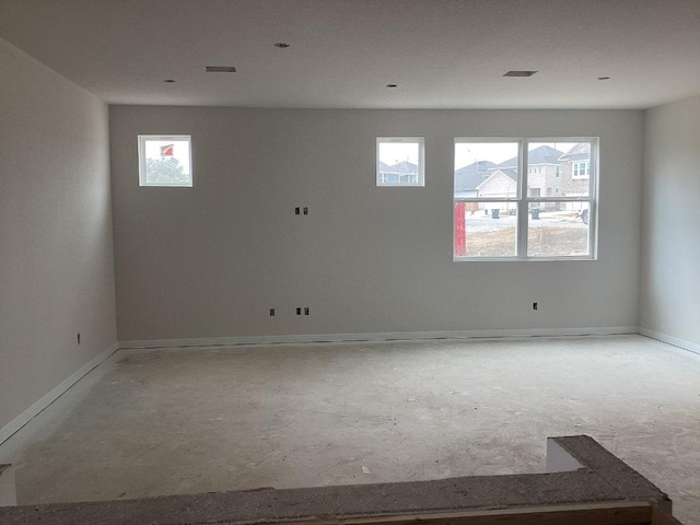 empty room with visible vents and baseboards