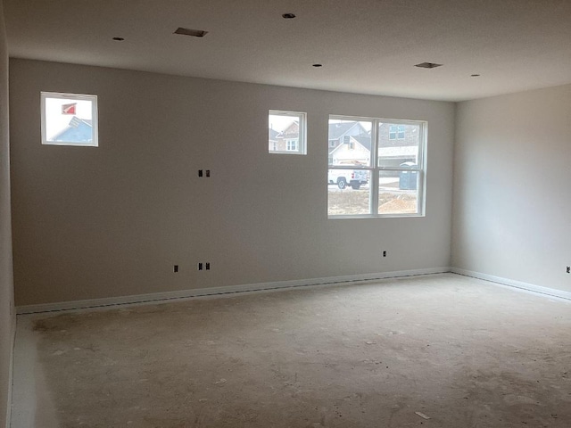 empty room with visible vents and baseboards