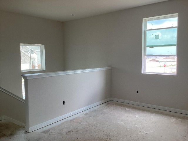 spare room with baseboards