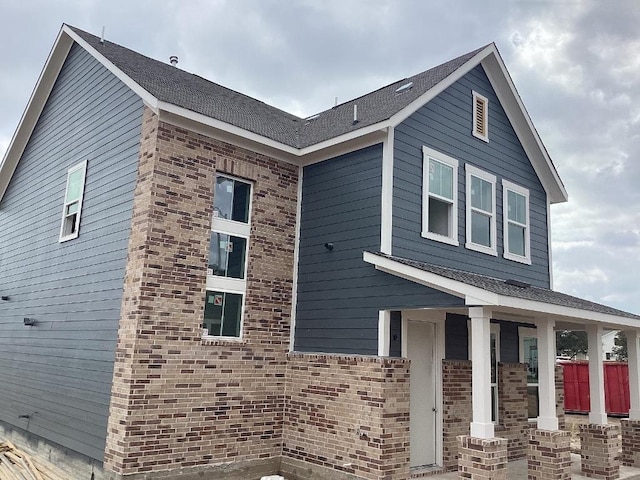 view of side of property featuring brick siding