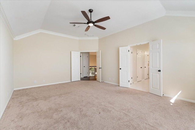 unfurnished bedroom featuring lofted ceiling, ornamental molding, carpet, and visible vents