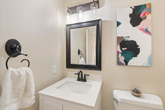 bathroom featuring toilet and vanity