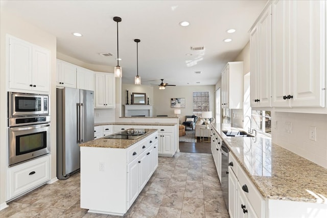 kitchen featuring white cabinetry, visible vents, appliances with stainless steel finishes, and a center island