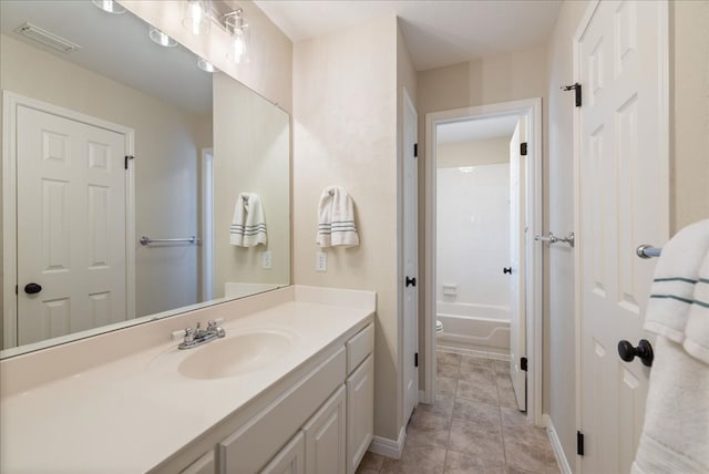 bathroom featuring visible vents, vanity, baseboards, and tile patterned floors