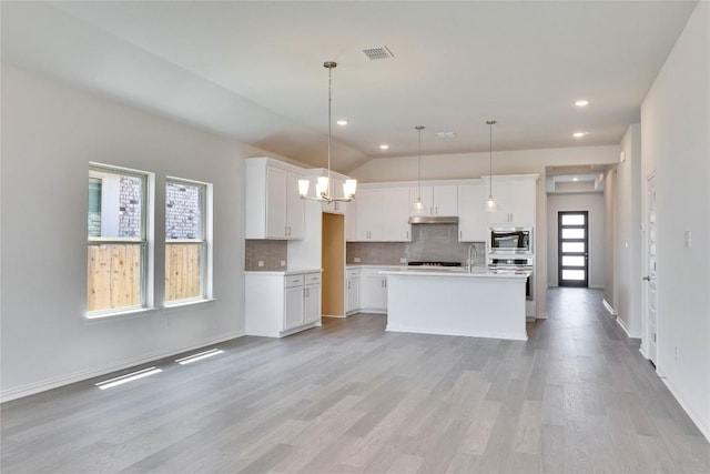 186 Du Bois Ln, Kyle, TX 78640 - kitchen featuring white cabinets, visible vents, backsplash, under cabinet range hood, and appliances with stainless steel finishes
