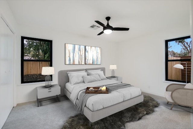 bedroom featuring ceiling fan, multiple windows, carpet, and visible vents