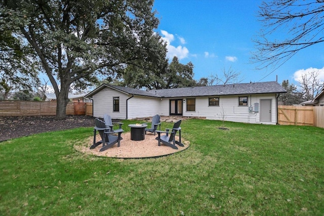 back of property featuring a patio area, a fenced backyard, a fire pit, and a lawn