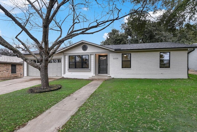 ranch-style house featuring a garage, driveway, brick siding, and a front yard