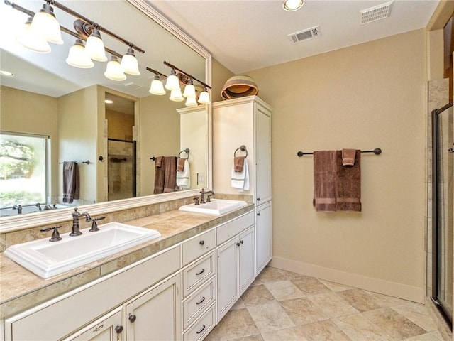 bathroom with a shower stall, visible vents, and a sink