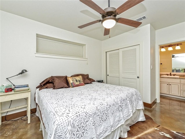 bedroom with finished concrete flooring, a closet, baseboards, ceiling fan, and a sink