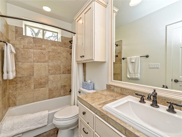 full bath featuring vanity, shower / bath combination with curtain, and toilet