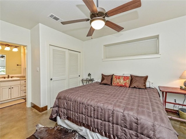 bedroom with finished concrete flooring, a closet, visible vents, a sink, and baseboards