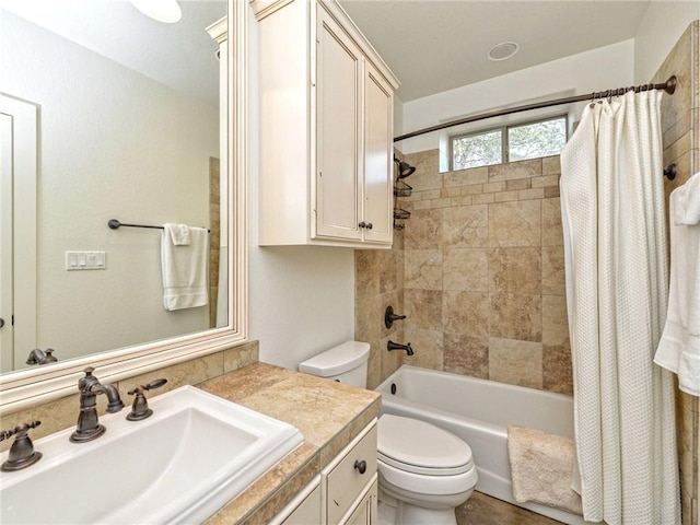 full bathroom featuring shower / bath combo, vanity, and toilet