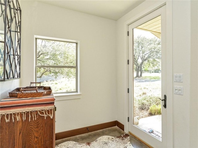 entryway with concrete floors and baseboards