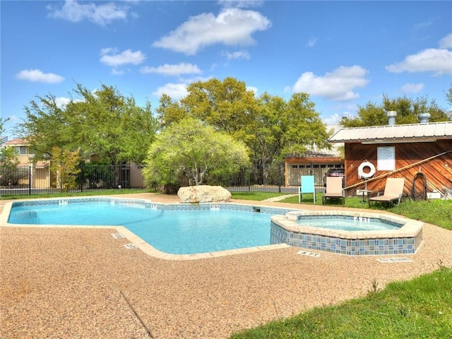 view of pool with a pool with connected hot tub and fence