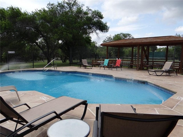 pool with fence and a patio