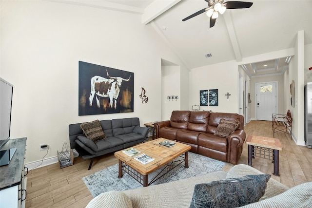 living area with baseboards, light wood-style flooring, high vaulted ceiling, and beam ceiling