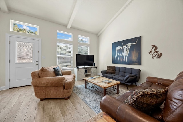 living area featuring light wood-style floors, high vaulted ceiling, and beamed ceiling