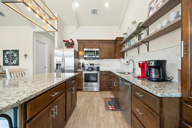 kitchen with light wood-style flooring, a sink, visible vents, appliances with stainless steel finishes, and open shelves