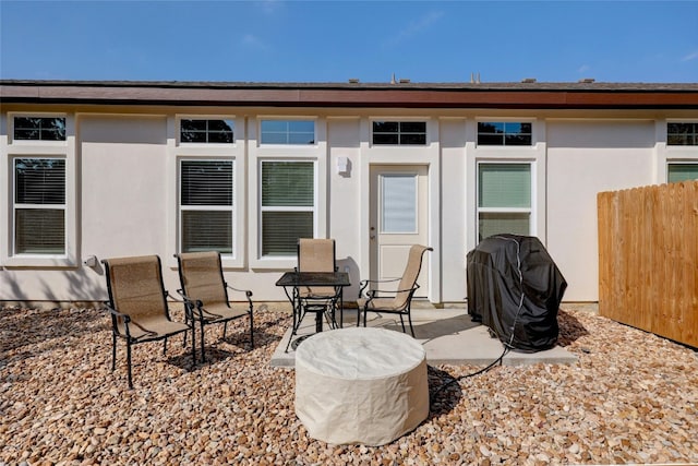 back of house featuring a patio area, fence, and stucco siding