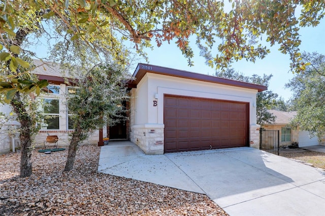 garage featuring concrete driveway