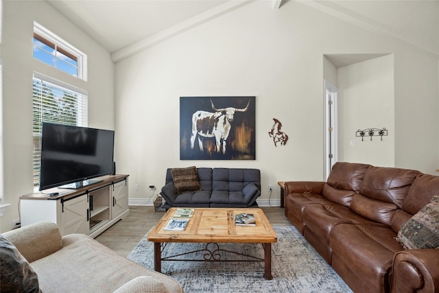 living room featuring light wood-style floors, lofted ceiling, and baseboards