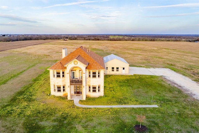 birds eye view of property with a rural view