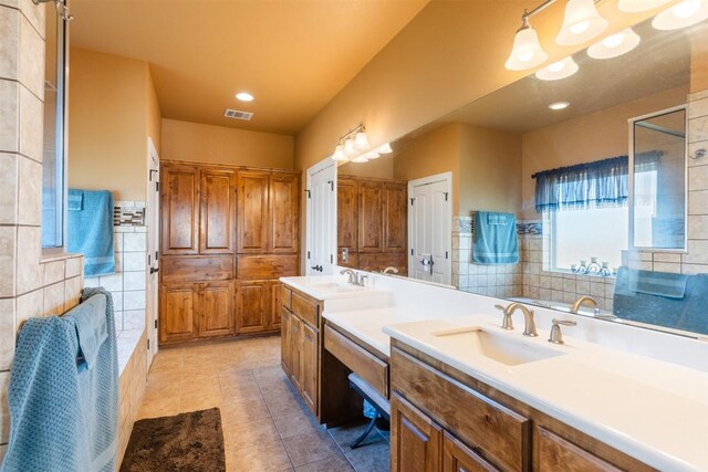 full bath with tile patterned flooring, recessed lighting, vanity, visible vents, and tile walls