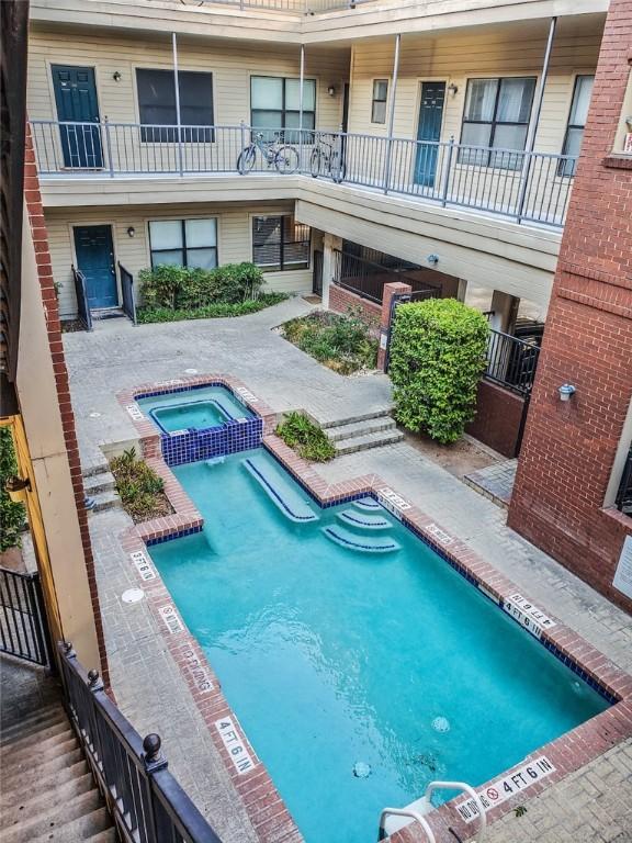 view of pool with a pool with connected hot tub