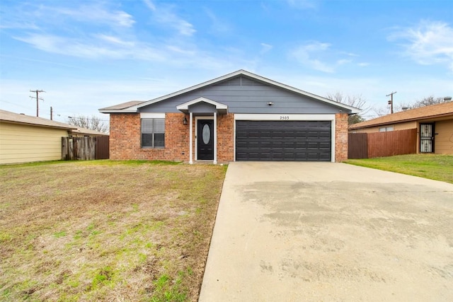 view of front of home featuring driveway, brick siding, an attached garage, and a front yard