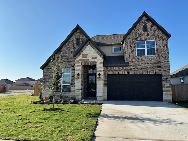 view of front of home with driveway, stone siding, a front lawn, and brick siding