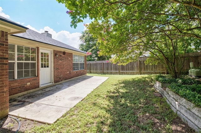 view of yard featuring fence and a patio