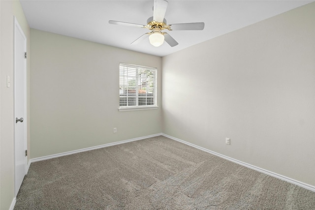 empty room featuring carpet floors, a ceiling fan, and baseboards