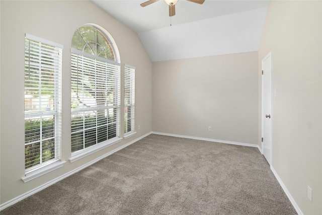 empty room featuring baseboards, a ceiling fan, vaulted ceiling, and carpet flooring