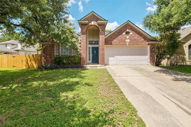 traditional home featuring driveway, an attached garage, fence, a front lawn, and brick siding