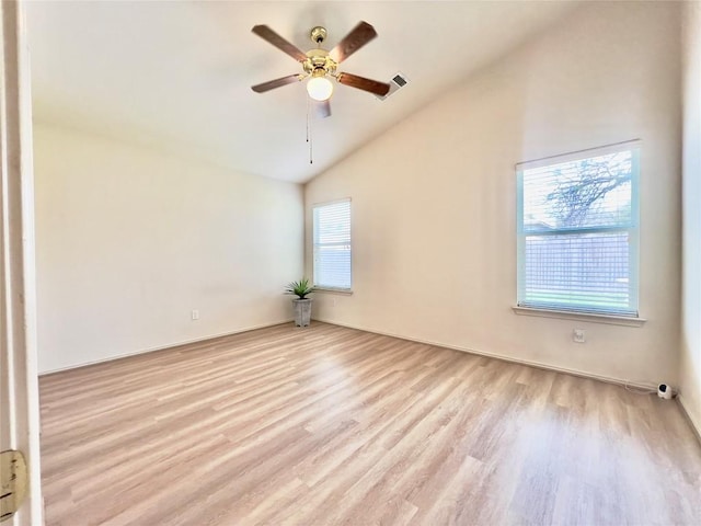 unfurnished room with vaulted ceiling, ceiling fan, wood finished floors, and a healthy amount of sunlight