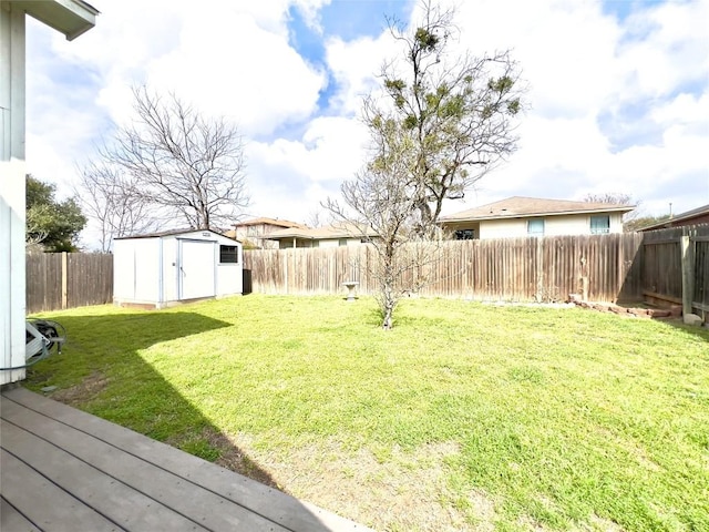 view of yard featuring a storage shed, an outdoor structure, and a fenced backyard