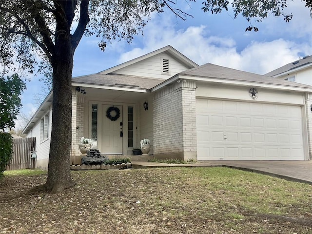 ranch-style home featuring a garage, driveway, brick siding, and fence