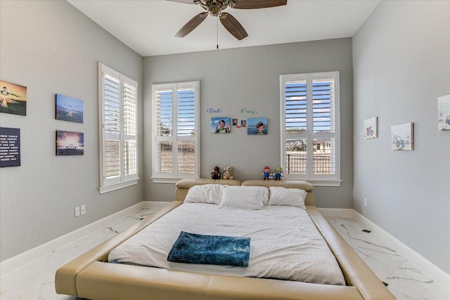 bedroom featuring marble finish floor, ceiling fan, and baseboards