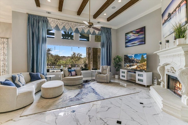 living area featuring marble finish floor, recessed lighting, beamed ceiling, and a high end fireplace