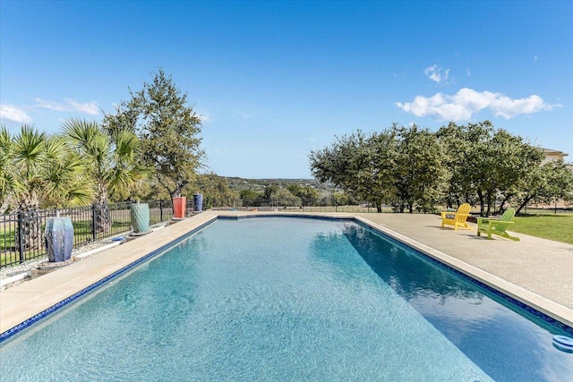 view of pool with a fenced in pool, a patio area, and fence