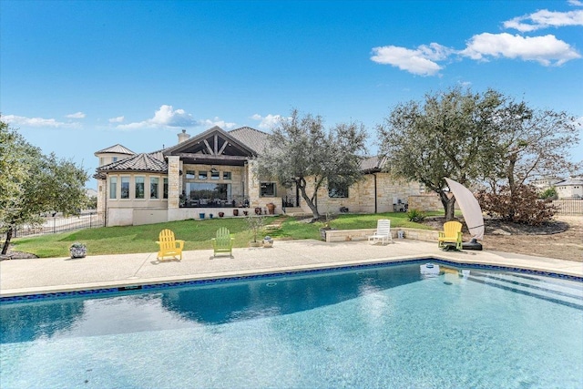 pool with a yard, a patio area, and fence