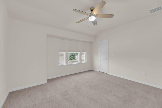 spare room with a ceiling fan, carpet, visible vents, and baseboards