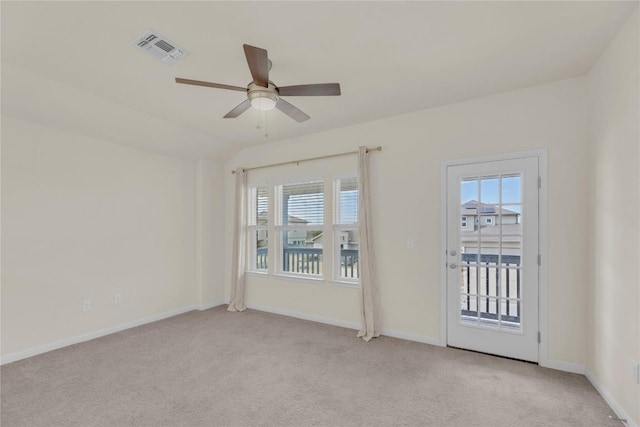 spare room featuring ceiling fan, light colored carpet, visible vents, and baseboards