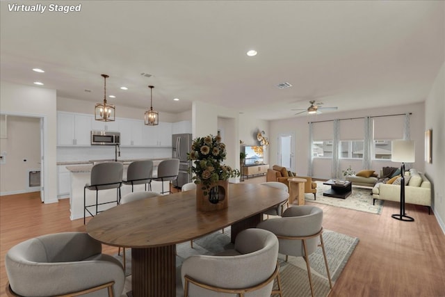 dining room with visible vents, baseboards, ceiling fan, light wood-type flooring, and recessed lighting