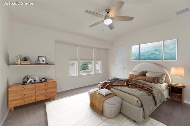 bedroom featuring light carpet, baseboards, visible vents, ceiling fan, and vaulted ceiling